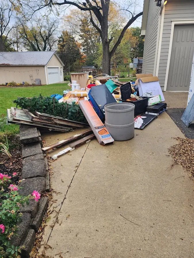 Dumpster being loaded with debris for Estate Cleanout Dumpster Rental in Longview Heights